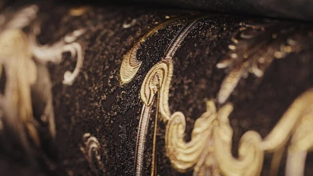Rolls with wallpaper. Ornament close-up. Stand with wallpaper in the store