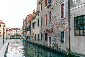 Fototapeta na wymiar View of the water channels, bridges and old palaces in Venice at sunset
