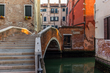 View of the  water channels, bridges and old palaces in Venice at sunrise during the lockdown