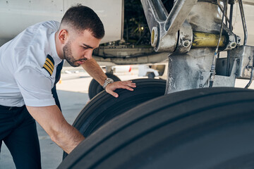 Serious young man leaning over the chassis © Svitlana