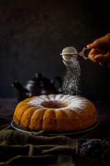 When pouring powdered sugar on the cake