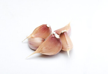 Closeup of heap of pieces of garlic on  the white background