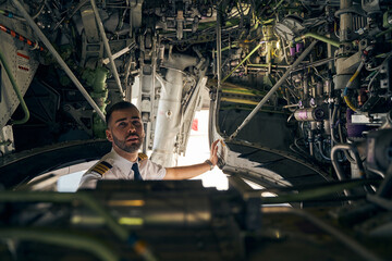 Focused young pilot inspecting an air vehicle © Svitlana
