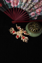 Chinese traditional wedding women's jewelry hairpins. fan and incense burner. still-life