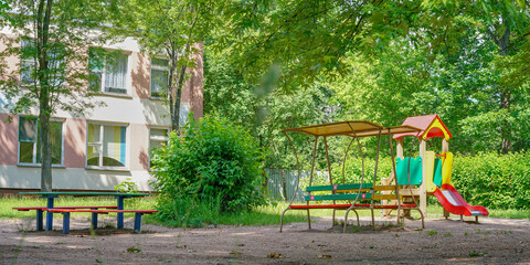 Fototapeta na wymiar local playground with colourful attractions and benches