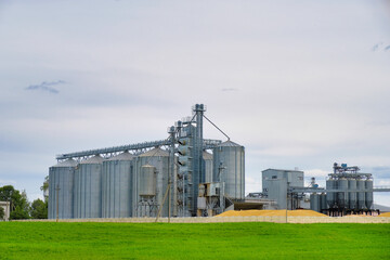Obraz premium Granary elevator. Agro manufacturing plant for processing drying cleaning and storage of agricultural products, flour, cereals and grain. Agribusiness concept