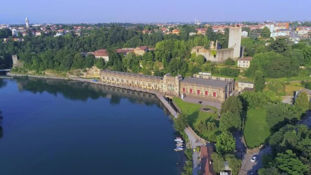 Aerial view of of the Castello Visconteo and Centrale Idroelettrica Taccani (Taccani hydroelectric power plant) on the shores of river Adda, Trezzo sull'Adda, Italy