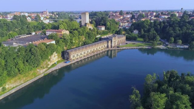 Aerial view of of the Castello Visconteo and Centrale Idroelettrica Taccani (Taccani hydroelectric power plant) on the shores of river Adda, Trezzo sull'Adda, Italy