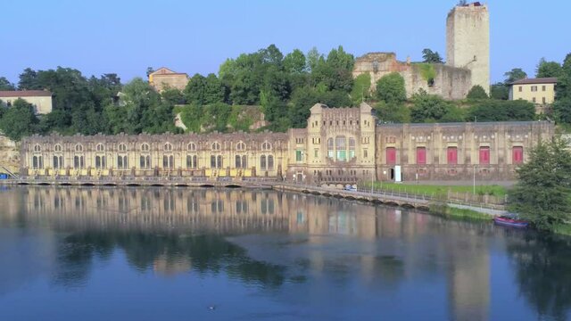 Aerial view of of the Castello Visconteo and Centrale Idroelettrica Taccani (Taccani hydroelectric power plant) on the shores of river Adda, Trezzo sull'Adda, Italy