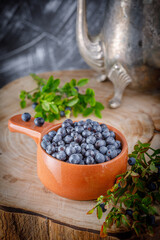 Fototapeta na wymiar fresh organic forest blueberries on wooden background
