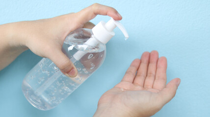 Woman washing hands with alcohol gel, antibacterial soap sanitizer consist of ethanol 70% based-cleaner hygiene for prevent the spreading of infection corona virus (COVID-19), sterile and antiseptic.