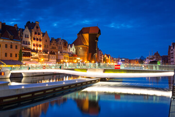 Amazing architecture of Gdansk old town at night with a new footbridge over the Motlawa River. Poland © Patryk Kosmider