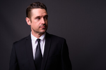 Portrait of handsome bearded businessman in suit