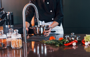 Professional young chef cook in uniform have a busy day on the kitchen