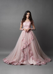 Fototapeta premium Beautiful bride on gray background. Portrait of a Bride in beautiful wedding dress.