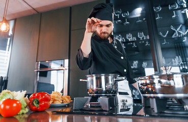 Professional young chef cook in uniform have a busy day on the kitchen