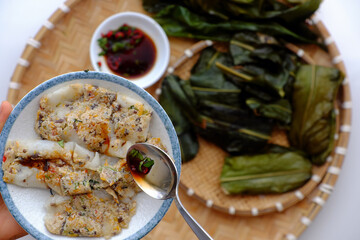 people eating flat rice dumpling on tray food background, special cake of Hue, delicious vegan rice flour dish