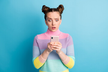 Photo of attractive amazed shocked teen lady two buns influencer freelancer hold telephone read...