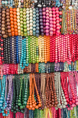 Many colorful new wooden jewelry with balls closeup
