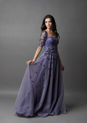 Beautiful bride on gray background. Portrait of a Bride in beautiful wedding dress.