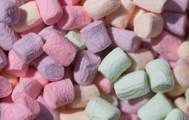 Colorful marshmallow top view. Pink, green, lilac and orange colors. Soft macro background. Holidays, childhood, party concept
