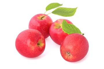 Four tasty red apples with leaves isolated on white