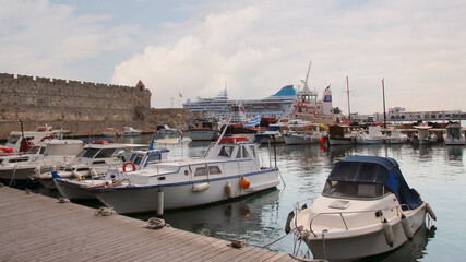 Fototapeta premium Rhodes, embankment and boats in Mandraki harbour, Rhodes, Greece
