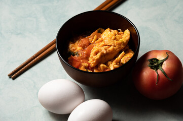 Scrambled eggs with tomatoes is a home cooked meal in Taiwan,China and other east asia area.Scrambled eggs with boiled tomatos,based with tomato sauce and pepper,sugar and salt.