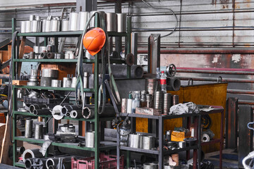 fragment of industrial interior with a storage of metal products and tools in the workshop