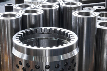 industrial background - new shiny steel hardware, parts of turbodrills of various diameters are in...
