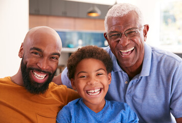 Portrait Of Multi-Generation Male African American Family Sitting On Sofa At Home - Powered by Adobe