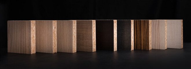 wooden texture chipboard laminate furniture material samples on black background. banner