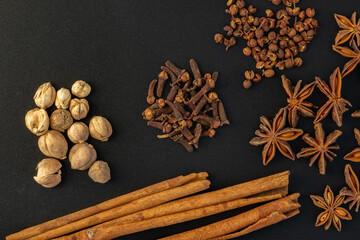 Assorted colorful spices on a black background. Healthy diet lifestyle.