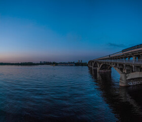 View of the metro bridge and the Dnipro river at sunset. Kiev, Ukraine