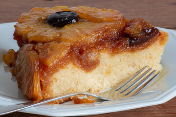 Caramelized pineapple cake with plums. Texture. Close-up. Piece of cake.