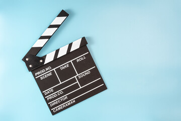 Movie clapperboard on blue background