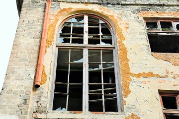 
Facade of an old building with broken windows