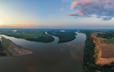 Aerial drone view of river landscape in sunny summer evening. Top view of siberian Ob river from high attitude in summer sunset. Panorama, bird's eye view