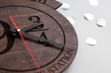 Wooden clock on a grey background
