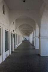 Fototapeta na wymiar Old colonnade in the red rows of shopping malls in Kostroma Russia close up