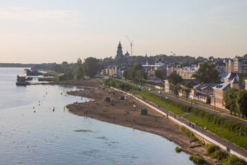 Naklejka premium Panoramic view of the embankment and the city beach of Kostroma on the Volga river Russia on a summer evening and space for copying