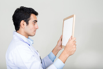 Portrait of young handsome Indian man doctor