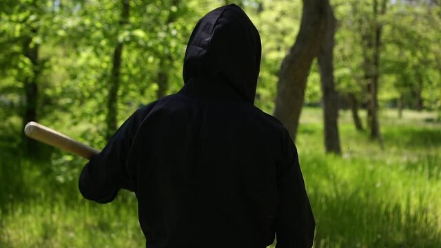 Japanese ninja is engaged in martial arts outdoors. Ninja in black clothes