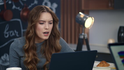 Angry businesswoman talking by video chat at home office. Business woman arguing