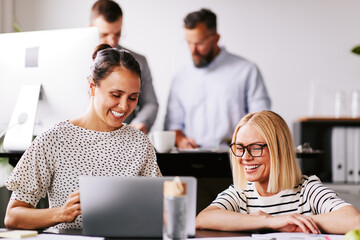 Two businesswomen talking at work