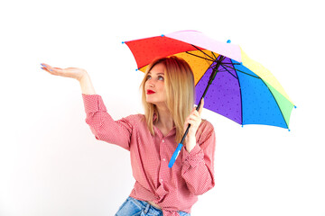 Young beautiful woman holding colored umbrella on white background