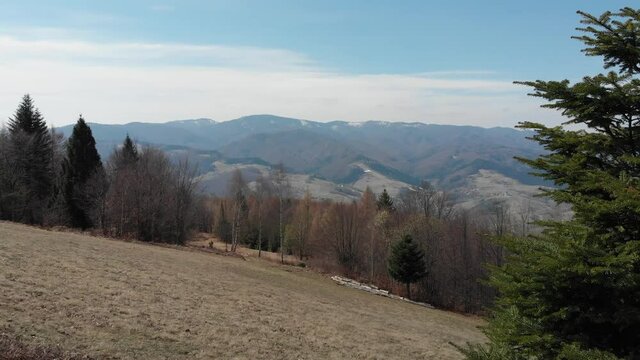 Flying over Beskids Mountains near Makowica in early spring. Rytro Village, Poland.