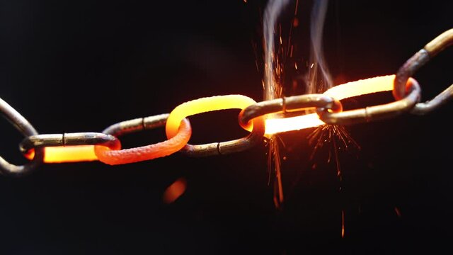 Weakest Link - Concept - Chain slowly heats up and starts to sparkle, then the weakest link finally brakes and then the rest of the chain collapses. Real-Time.