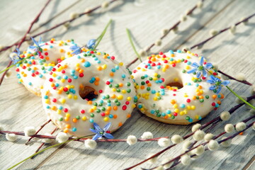 Delicious Easter cakes among spring flowers and willow branches.