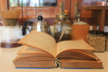 A close up of old books opened On the table in a coffee shop